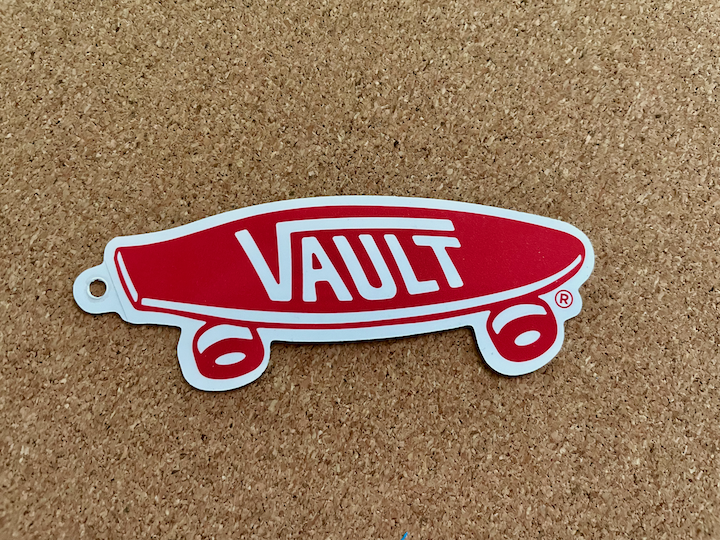 a VANS skateboarding shoe company logo that says "Vault"