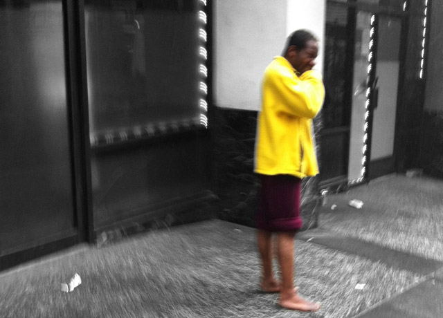 homeless shoeless man wearing yellow